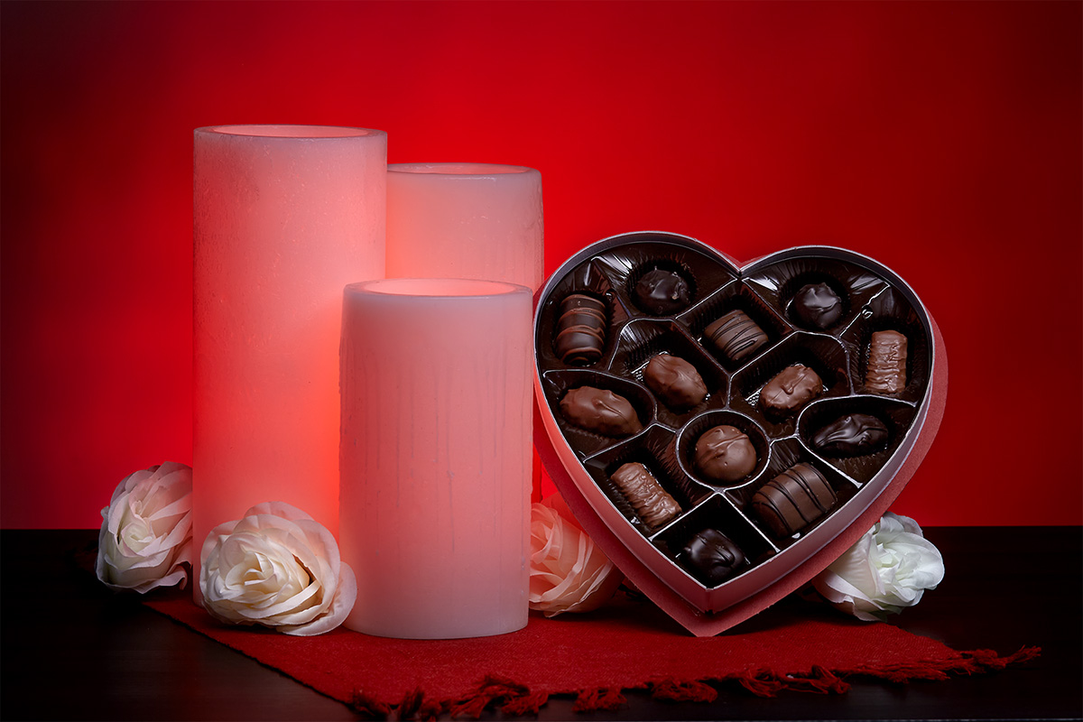 Red Valentines Day Flameless Candles with a Box of Chocolates