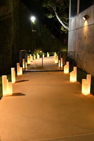 TOI Event Path Entrance Illuminated with Large Wax Luminaries